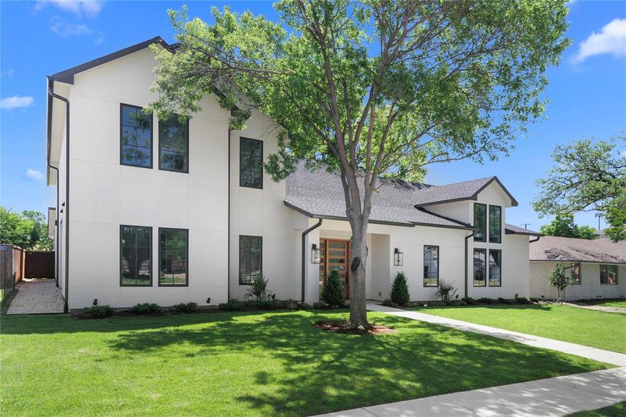 Modern home featuring stucco siding and roof with shingles Modern home featuring stucco siding and roof with shingles