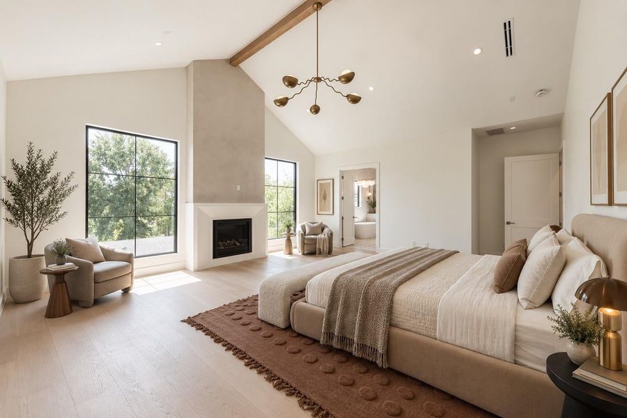 A second perspective reveals the true scale of the primary suite, where the cathedral ceiling, fireplace and dedicated sitting area give the room the feel of a private residence within the home. A second perspective reveals the true scale of the primary suite, where the cathedral ceiling, fireplace and dedicated sitting area give the room the feel of a private residence within the home.