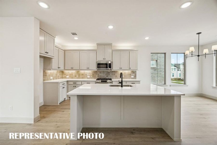 This dream home features a spacious kitchen island where friends and family are sure to gather round!  REPRESENTATIVE PHOTO