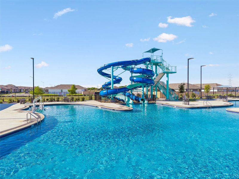 Resort-style aquatic amenity featuring a large swimming pool, integrated water slides, and expansive concrete decking Resort-style aquatic amenity featuring a large swimming pool, integrated water slides, and expansive concrete decking