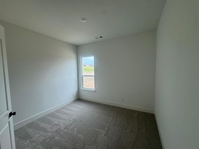 Room featuring neutral-toned carpet flooring, white painted walls, and a recessed ceiling light