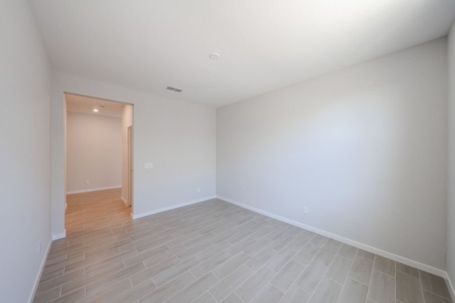 A room with a wood floor and white walls.