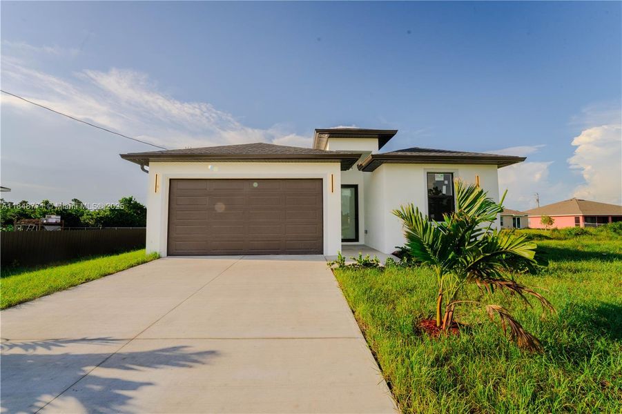 Front exterior of a new home in , Lehigh Acres, FL, highlighting curb appeal (Image 2). Front exterior of a new home in , Lehigh Acres, FL, highlighting curb appeal (Image 2).