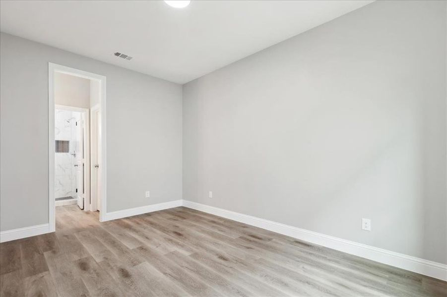 Empty room with hardwood / wood-style floors