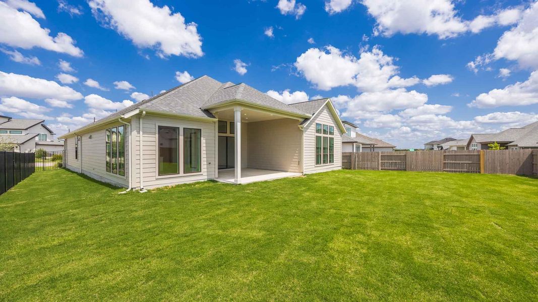 Rear view of house featuring a fenced backyard, a patio area, and a shingled roof Rear view of house featuring a fenced backyard, a patio area, and a shingled roof
