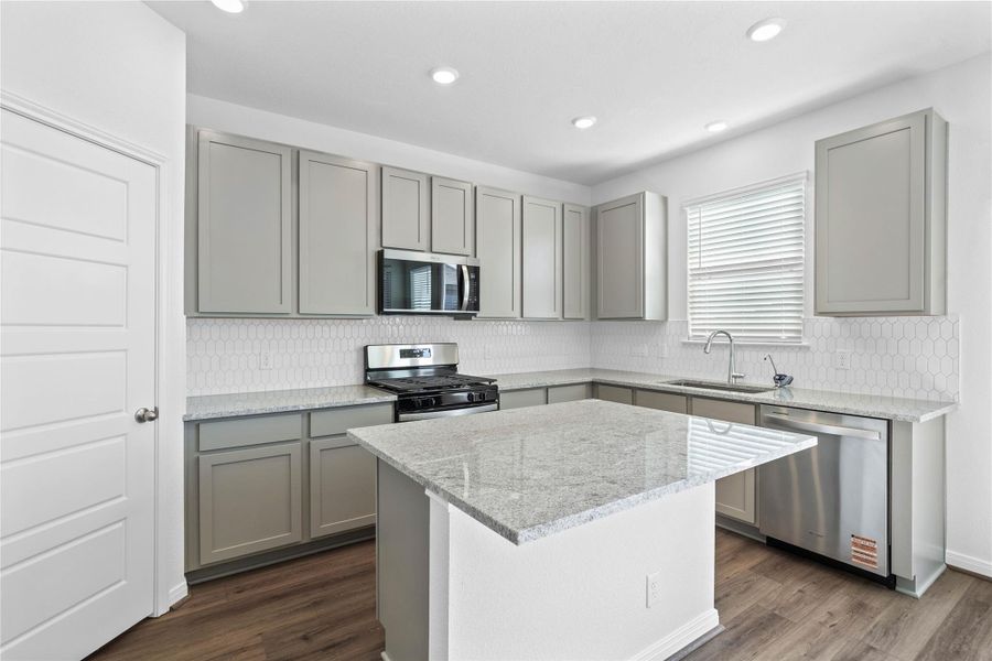 The added breakfast bar to the kitchen granite island provides additional seating—perfect for a quick meal—while keeping you connected to conversations in both the kitchen and dining area.