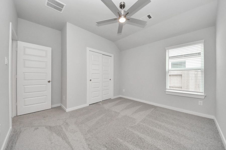Generously sized secondary bedrooms featuring spacious closets, soft and inviting carpeting underfoot, large windows allowing plenty of natural light, and the added touch of privacy blinds for your personal retreat.