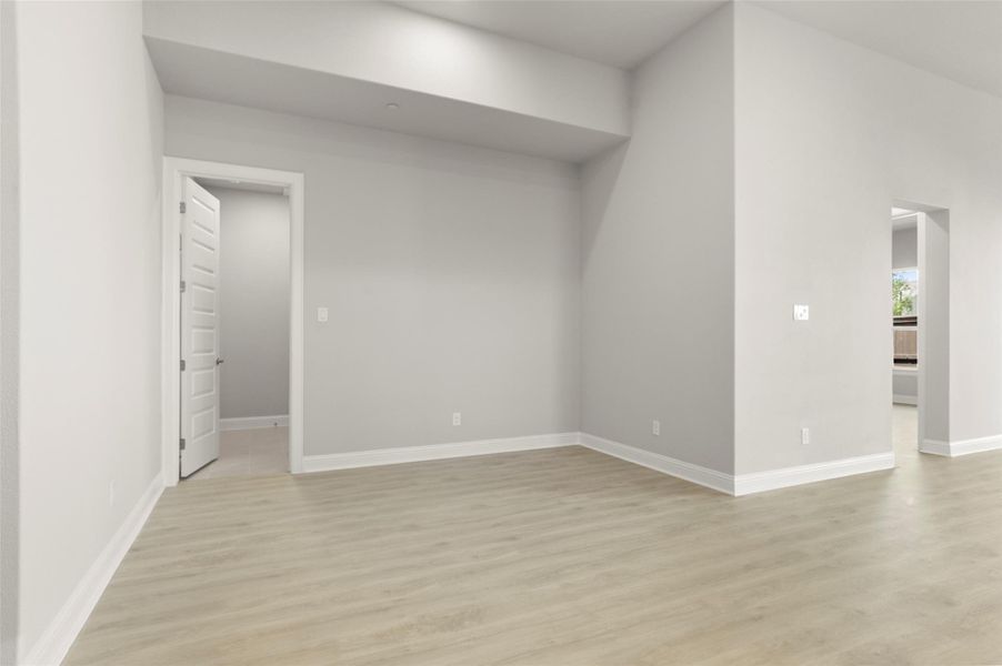 Spare room with light wood-type flooring and baseboards Spare room with light wood-type flooring and baseboards