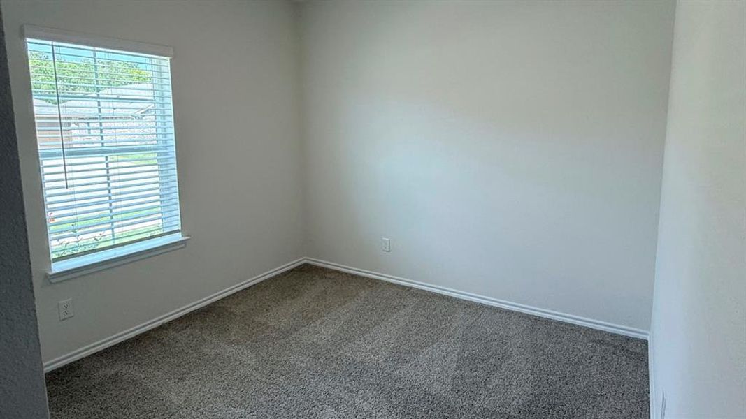 Carpeted empty room featuring baseboards Carpeted empty room featuring baseboards