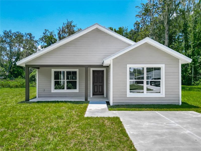 Front exterior of a new home in , Lake Panasoffkee, FL, highlighting curb appeal (Image 20).