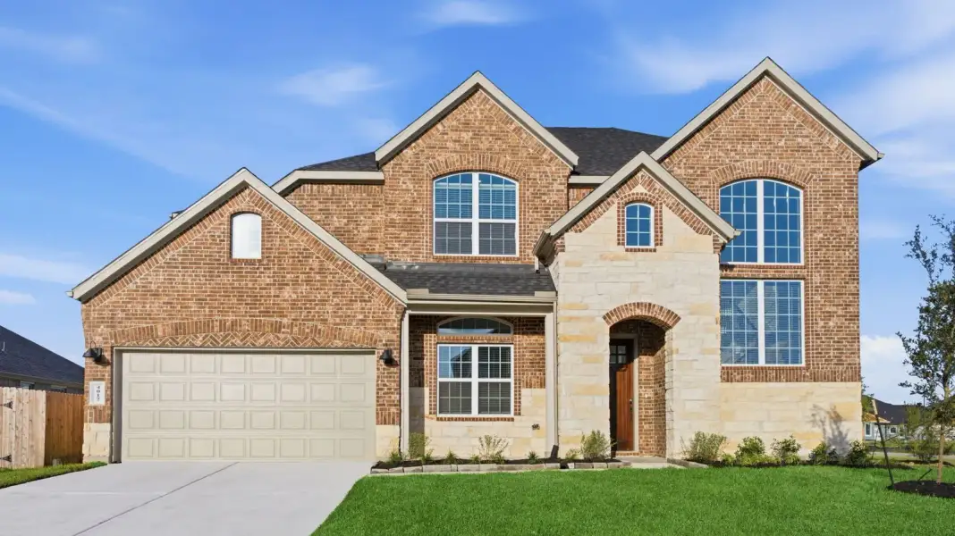 Front exterior of a new home in Lago Mar 60' Homesites, Texas City, TX, highlighting curb appeal (Image 2). Front exterior of a new home in Lago Mar 60' Homesites, Texas City, TX, highlighting curb appeal (Image 2).