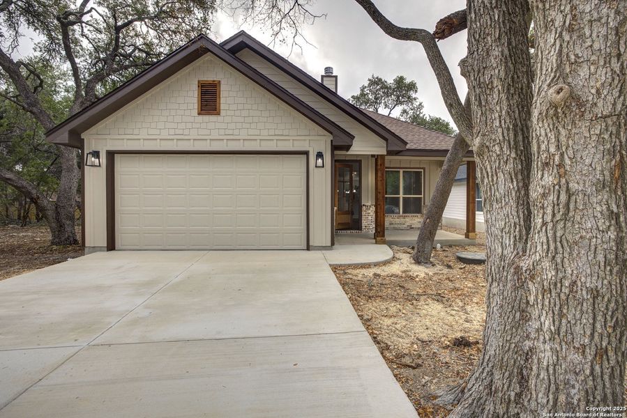 Front exterior of a new home in , Wimberley, TX, highlighting curb appeal (Image 1).