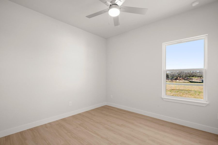 Unfurnished room with light wood-style floors and ceiling fan