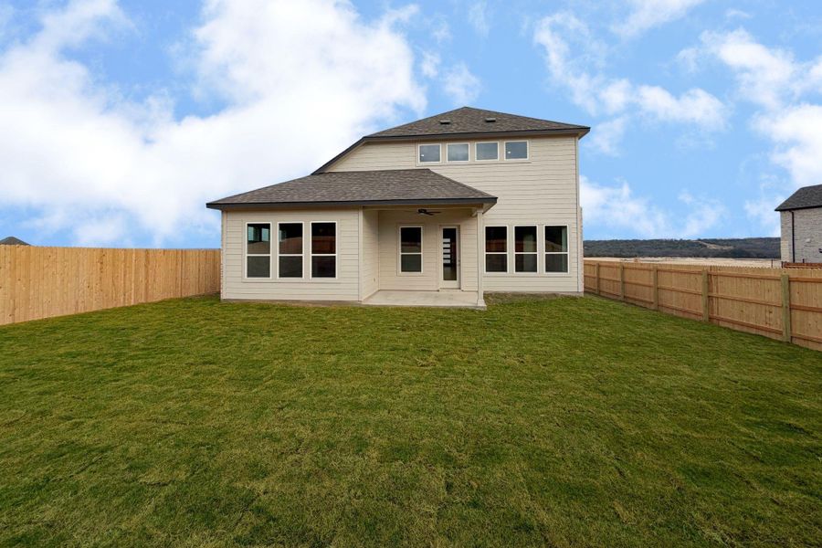 Rear view of house with a patio area, a fenced backyard, a ceiling fan, and roof with shingles