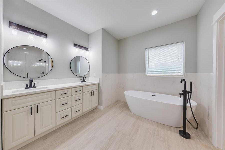 Primary bath with a luxurious soaking tub, perfect for unwinding and enjoying a relaxing, spa-like experience.