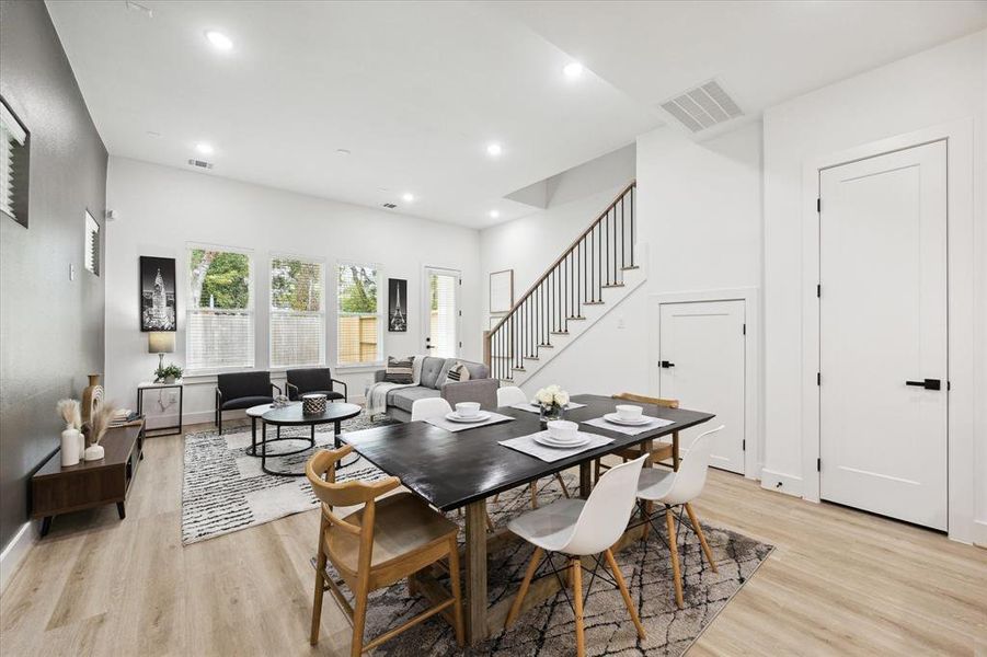 A cleverly positioned storage closet beneath the staircase maximizes the home's usable space. The door on the left opens to a generous 20x20 yard, offering ample outdoor space.