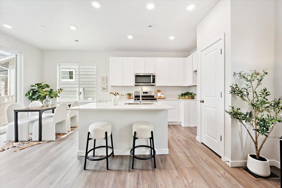 A kitchen with white cabinets. A kitchen with white cabinets.