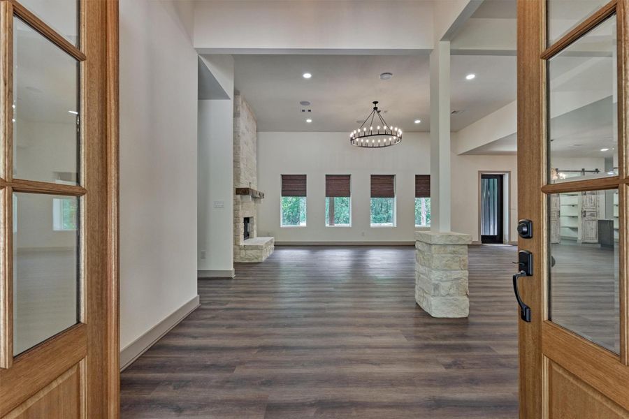 The expansive living area welcomes you with a wall of windows offering peaceful views of the trees and provides abundance of natural light