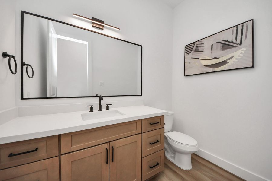 Discover the convenience of a sleek half bathroom on the first floor, featuring modern fixtures and elegant design for stylish functionality.