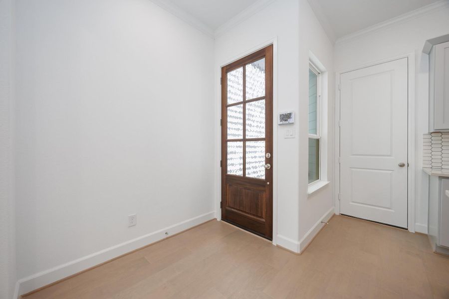 Welcome home. The warm wood door and crisp white walls set the tone for timeless style and modern comfort from the moment you walk in.