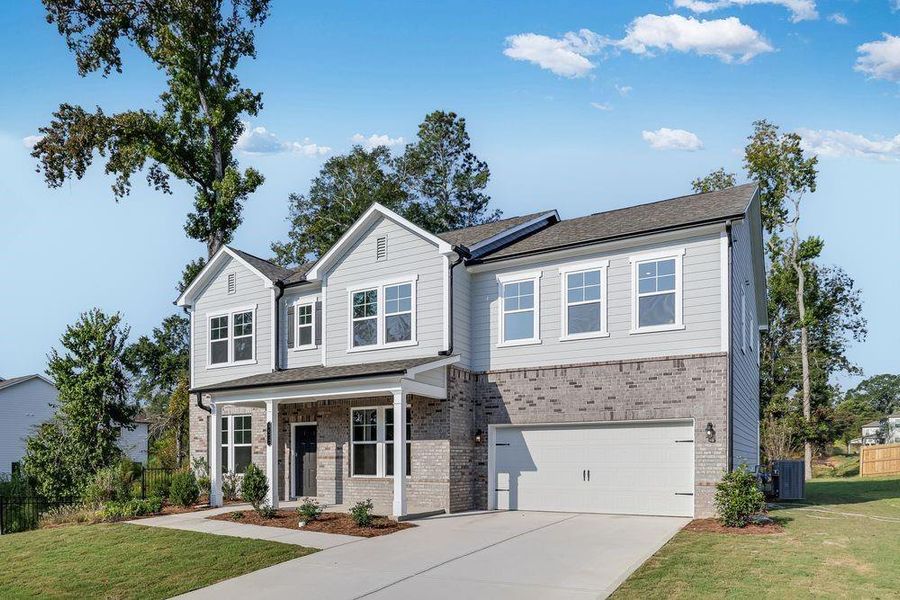 Front exterior of a new home in Kennison Creek, Cumming, GA, highlighting curb appeal (Image 1).