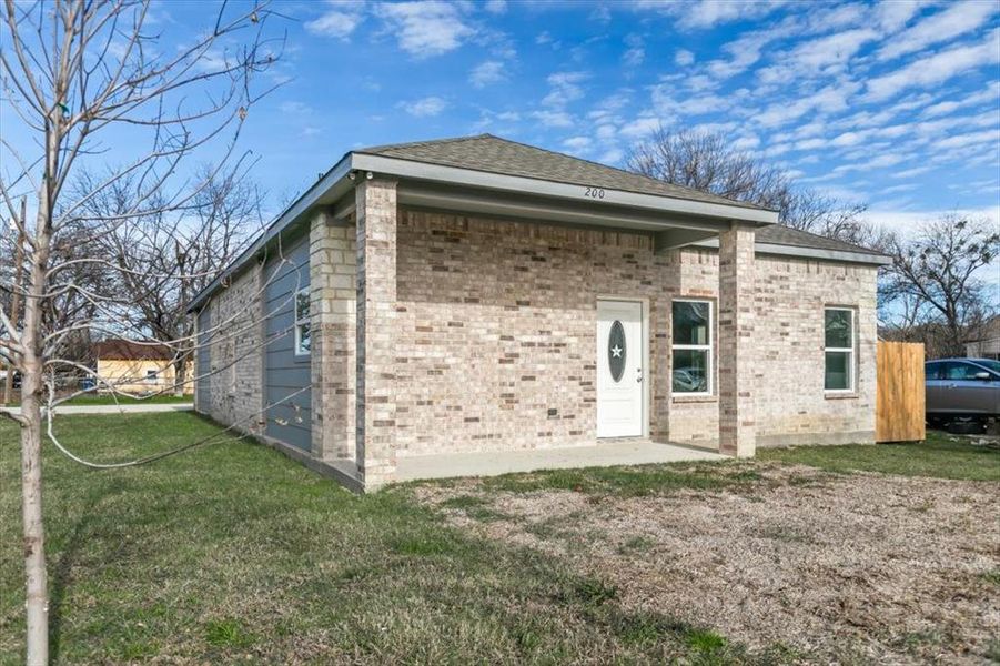 Rear view of property featuring a yard and a patio area