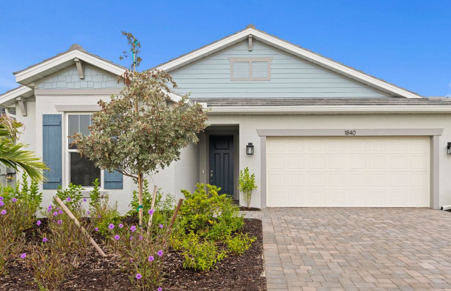 Front exterior of a new home in Shores at Stillwater, Englewood, FL, highlighting curb appeal (Image 21).