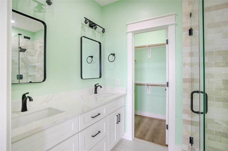 Primary bath with double sinks, large closet and expertly crafted glass-walk in shower!