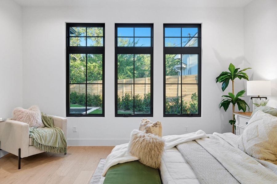 Bedroom featuring wood finished floors and baseboards Bedroom featuring wood finished floors and baseboards