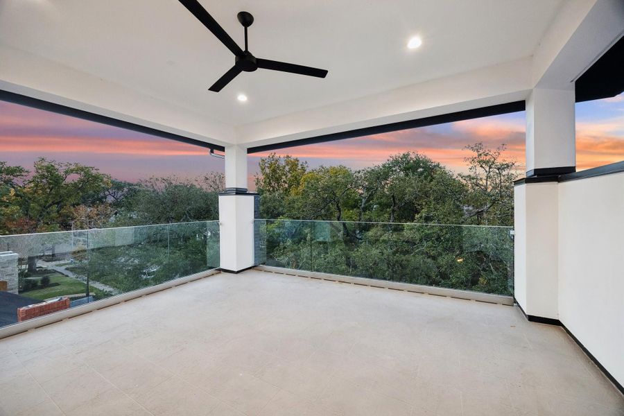 Covered Roof-Top Terrace with Westcoat ALX Waterproofing System with Decorative Overlay Finish. There is a glass railing, on the north and west side of the terrace and a stucco wall on the east side.