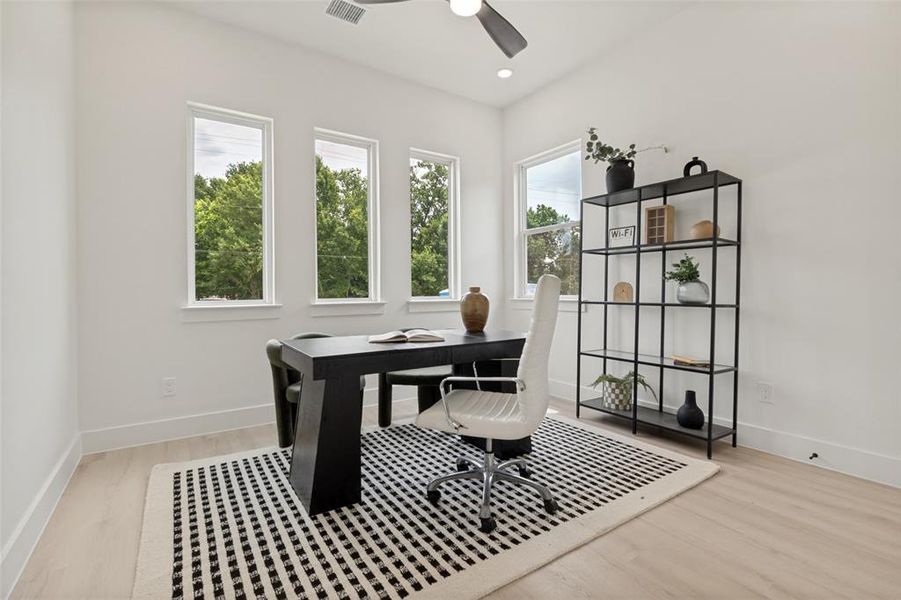 Versatile room featuring light wood-finish flooring, recessed lighting, and a ceiling fan