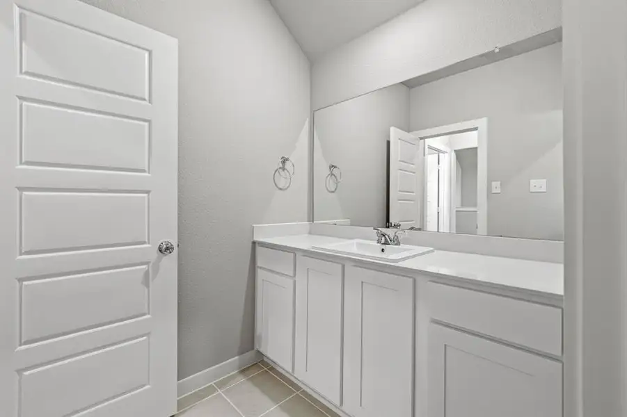 Bathroom with tile flooring and vanity