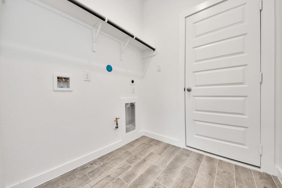 A perfect blend of functionality and comfort. Capture the essence of easy living with a first-floor laundry room, thoughtfully equipped with shelving for effortless organization. Both electric and gas connections available. A perfect blend of functionality and comfort. Capture the essence of easy living with a first-floor laundry room, thoughtfully equipped with shelving for effortless organization. Both electric and gas connections available.