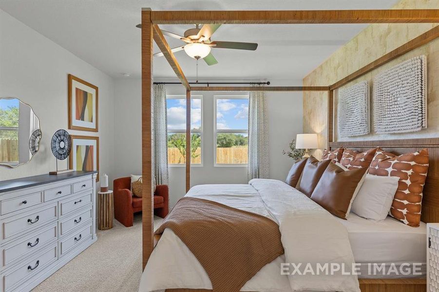 Carpeted bedroom with ceiling fan