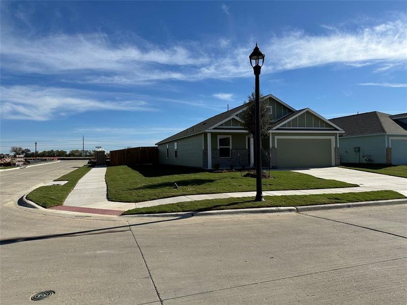 Single story home with a garage and a front yard