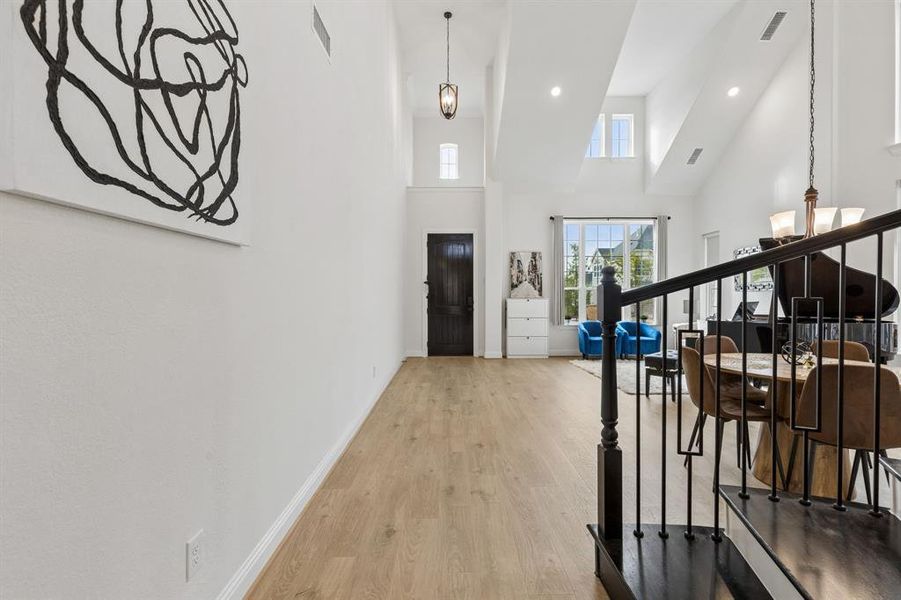 Vaulted ceilings featuring recessed lighting and upper architectural windows