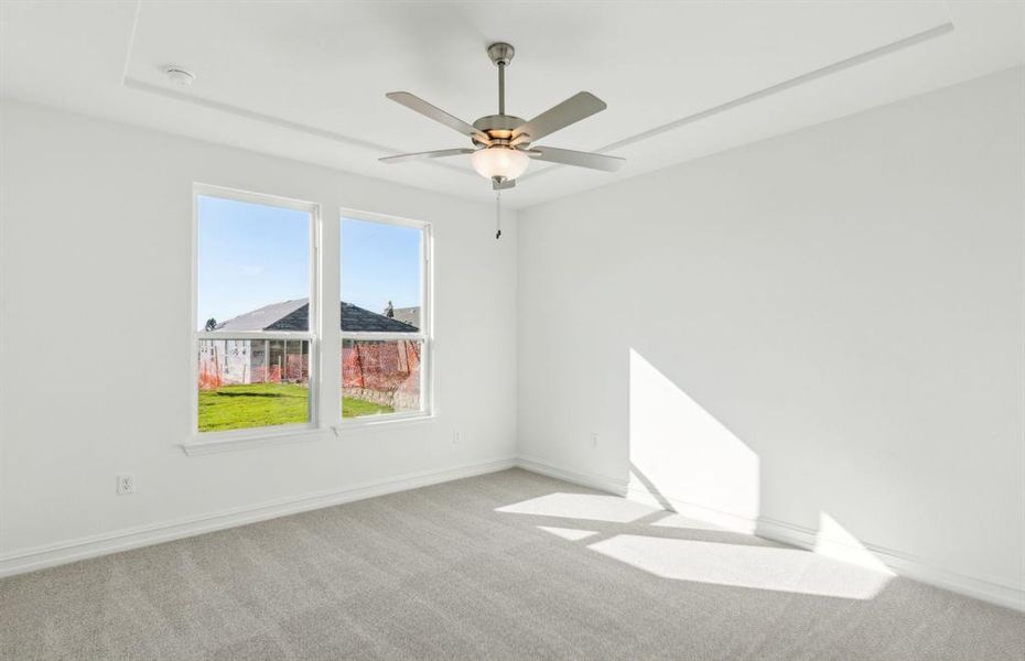 Elegant owner's suite with Tray ceiling *real home pictured