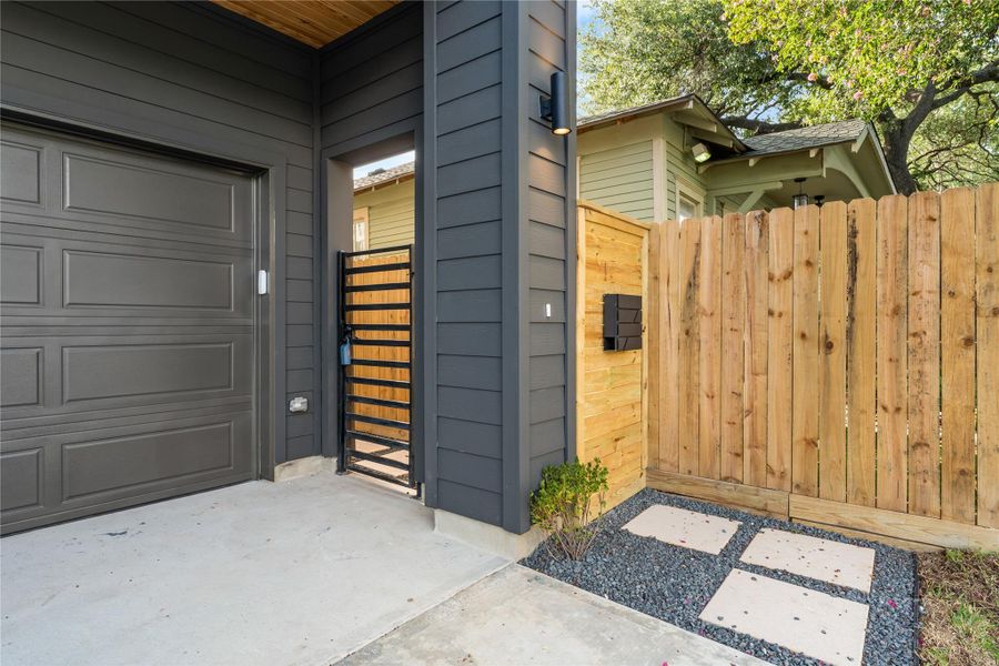 Private metal gate with deadbolt for security and allowing pets to roam freely between the backyard and side yard. This thoughtfully designed entryway also allows for your trash can to sit out of site (behind pillar). Private metal gate with deadbolt for security and allowing pets to roam freely between the backyard and side yard. This thoughtfully designed entryway also allows for your trash can to sit out of site (behind pillar).