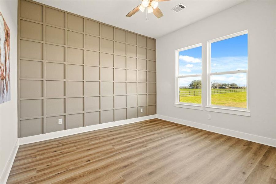 This Secondary Bedroom boasts all the same features as the prior, only this one boasts a stylish accent wall, and the two windows overlook the Backyard. This Bedroom also shares the previously seen Bathroom.