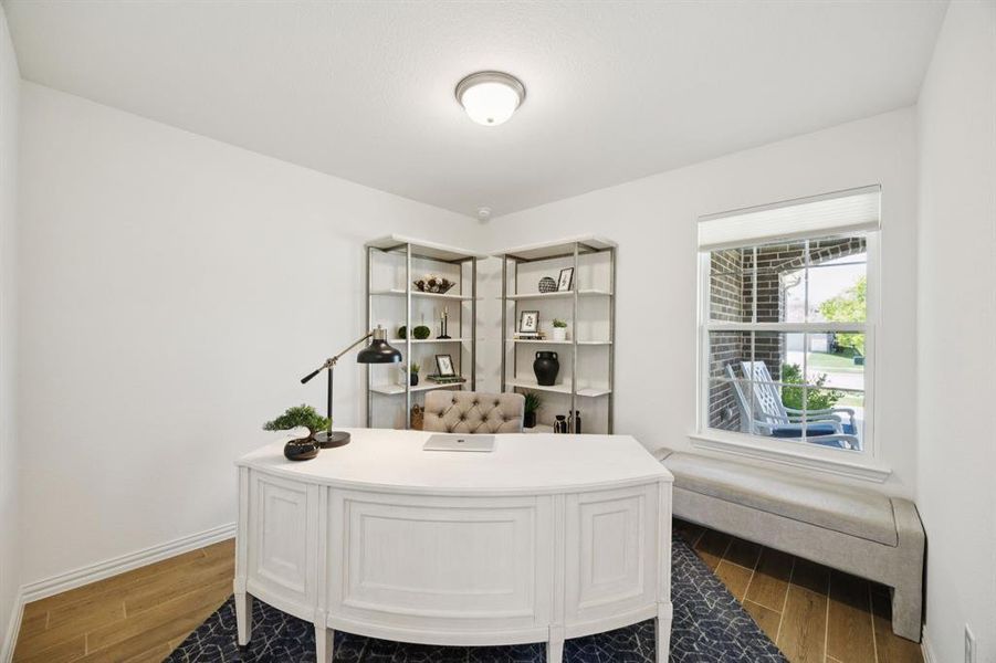 The spacious study offers views of the front porch, wood look tile flooring and a closet (which allows you to consider making it a third bedroom if needed).