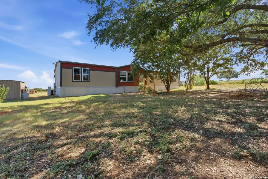 Exterior details and patio area of a home in , Devine (Image 24).