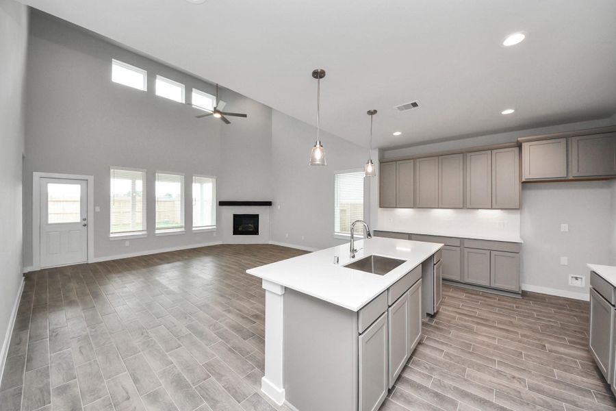 All of this overlooks your expansive family room, creating a perfect space for culinary delights and family gatherings. Sample photo of completed home with similar floor plan. Actual colors and selections may vary.