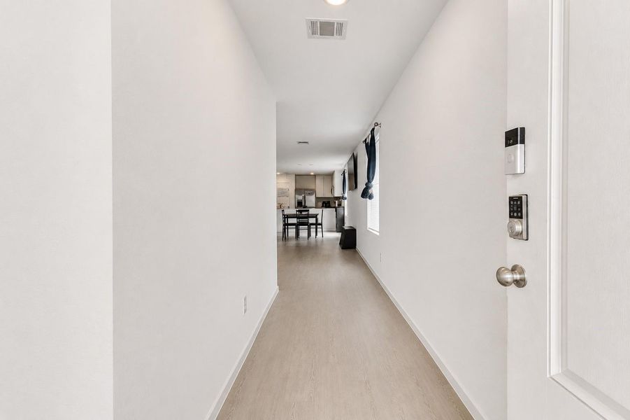 Welcoming entry foyer with durable luxury vinyl plank flooring and an open view into the main living areas.