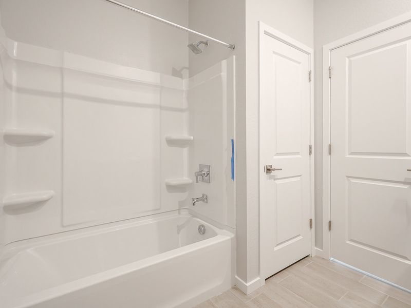 A bathroom with a tub sink and toilet.