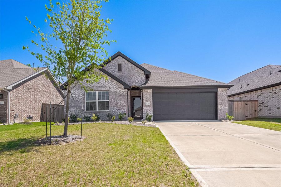 Front exterior of a new home in Oakwood Estates, Waller, TX, highlighting curb appeal (Image 1).