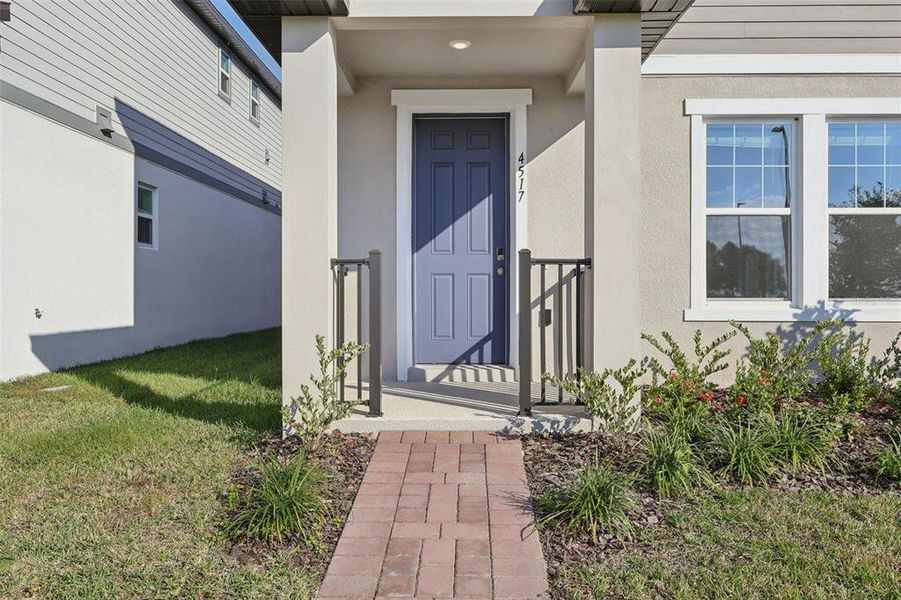 Exterior details and patio area of a home in The Meadow at Crossprairie Bungalows, St. Cloud (Image 3).