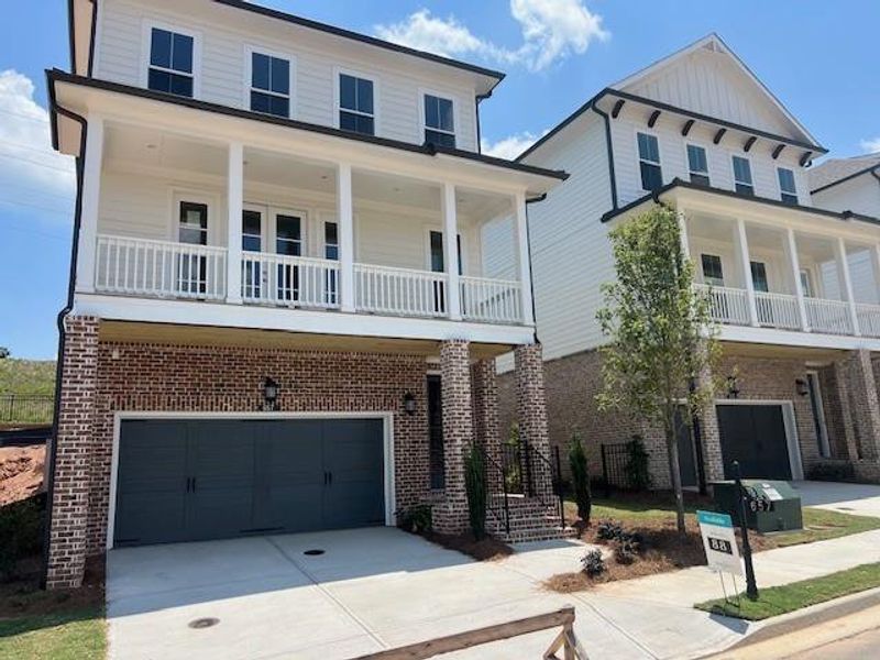 Front exterior of a new home in Palisades Single Family, Cumming, GA, highlighting curb appeal (Image 24).