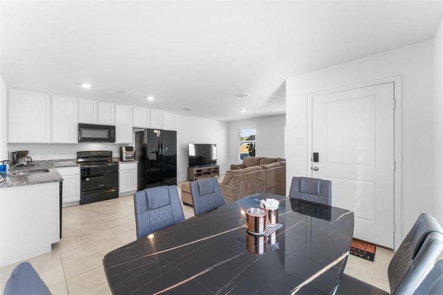 Dining room with light tile patterned floors and recessed lighting Dining room with light tile patterned floors and recessed lighting