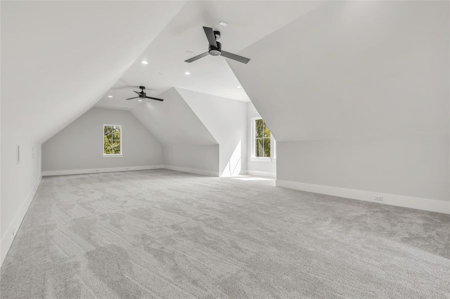 Bonus room with vaulted ceiling, ceiling fan, carpet, plenty of natural light, and recessed lighting
