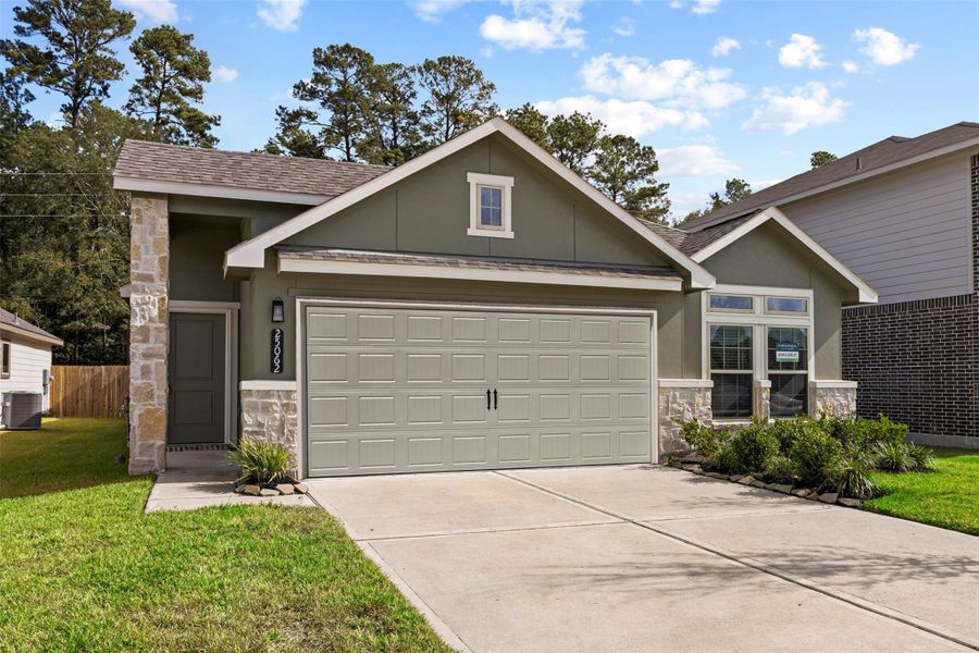 Front exterior of a new home in Enclave at Dobbin, Magnolia, TX, highlighting curb appeal (Image 1). Front exterior of a new home in Enclave at Dobbin, Magnolia, TX, highlighting curb appeal (Image 1).